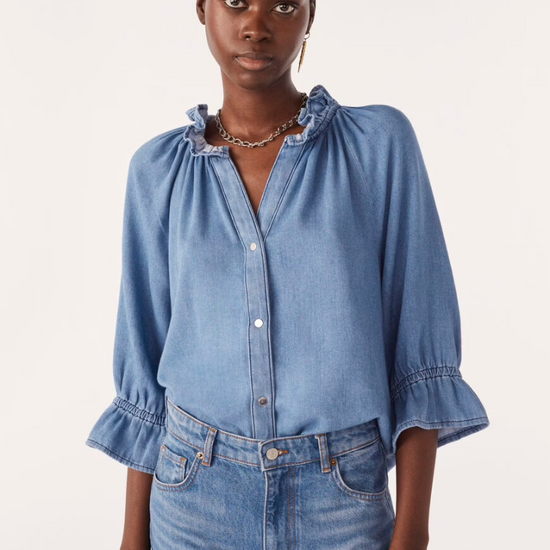 blue denim shirt with ruffled neck and cuffs model shot