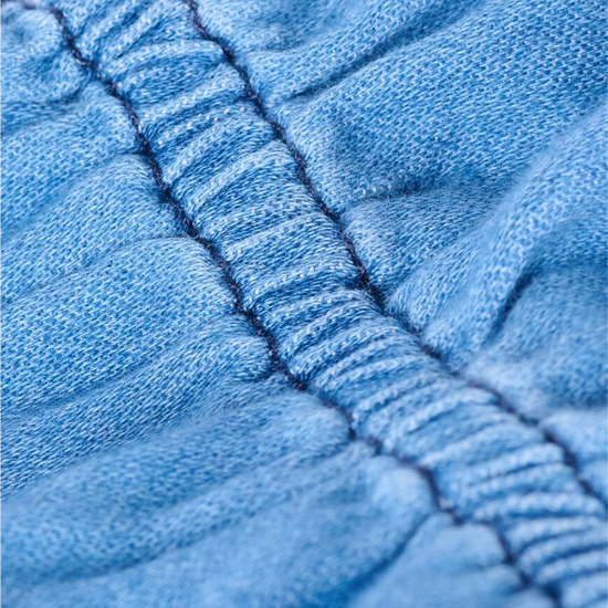 blue denim shirt with ruffled neck and cuffs close up of fabric