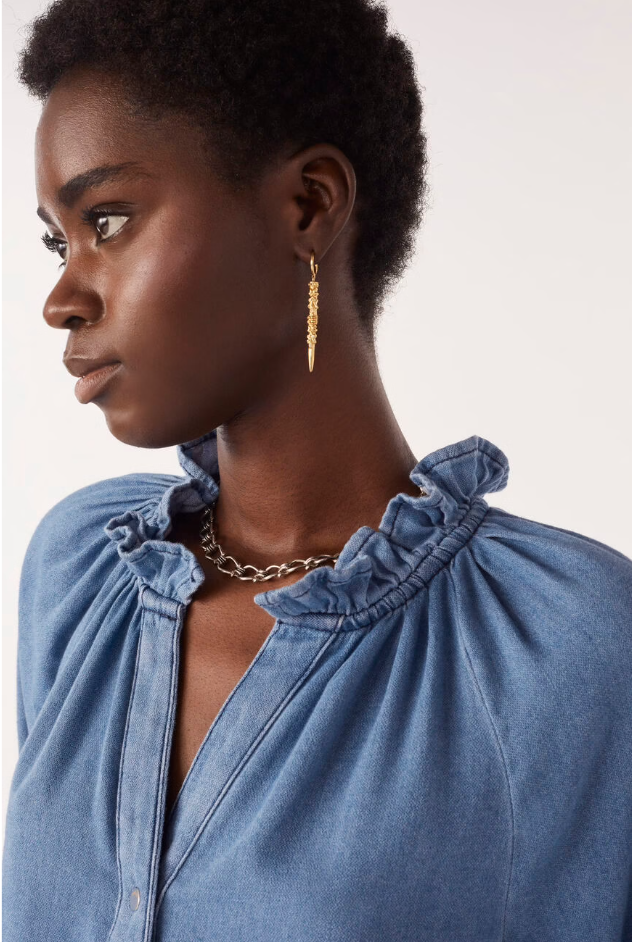 blue denim shirt with ruffled neck and cuffs close up