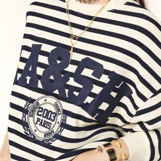 Navy and white striped sweatshirt with a blue decal on the front close up of front