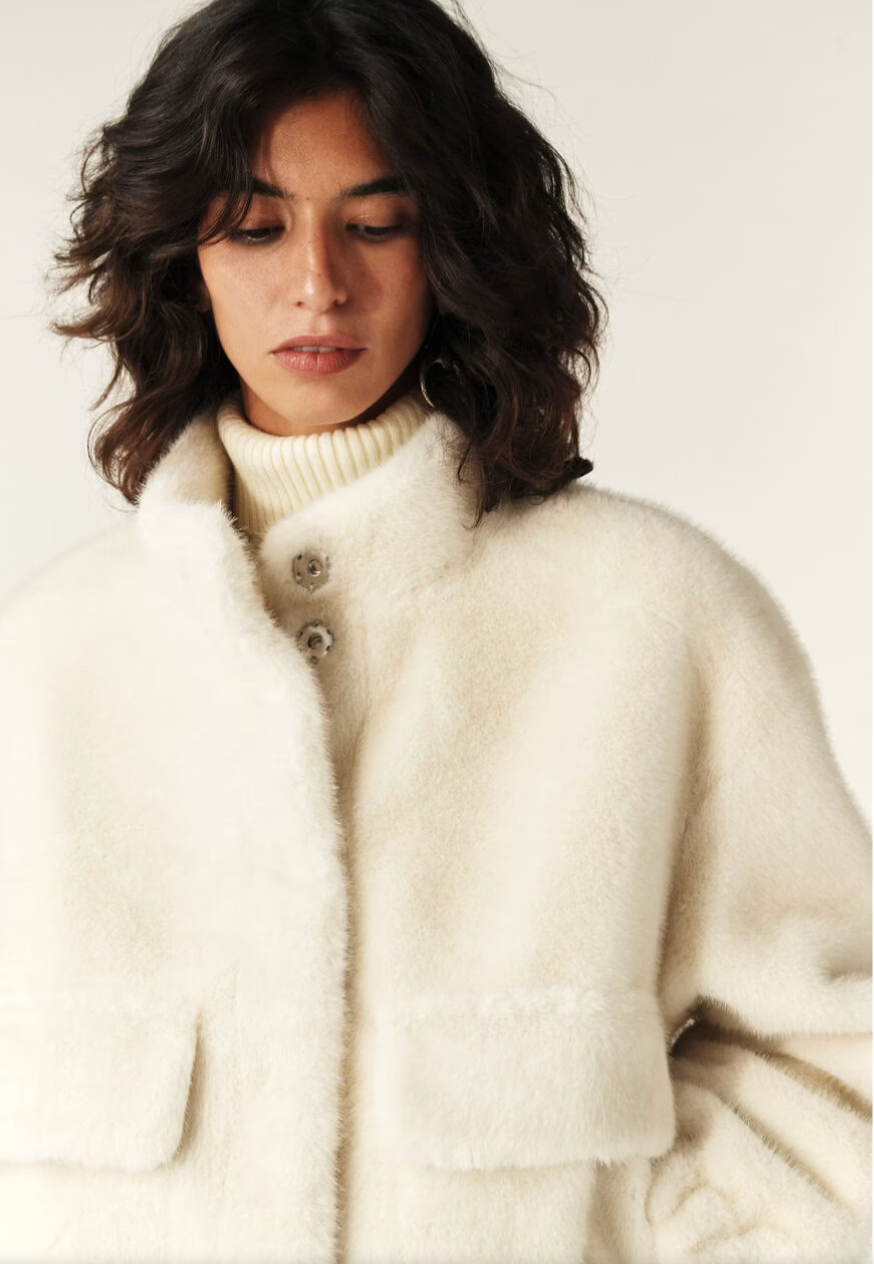 off white faux fur jacket with elasticated waist and cuffs with high neck and pockets  close up