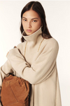 beige jumper dress with ribbed neck and cuffs and turtle neck close up