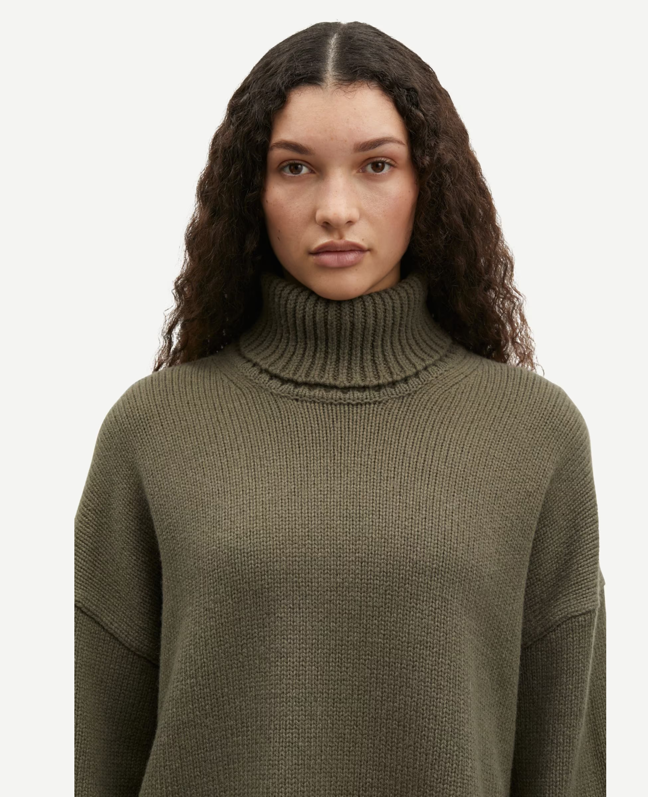 dark green turtle neck ribbed jumper with dropped shoulders close up