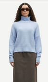 light blue turtleneck jumper with ribbed cuffs, hem and neck