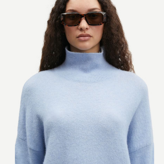 light blue turtleneck jumper with ribbed cuffs, hem and neck close up