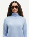 light blue turtleneck jumper with ribbed cuffs, hem and neck close up