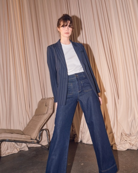 Model shot of navy pinstripe blazer worn with jeans