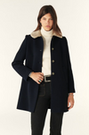 navy 3/4 length coat with faux fur collar, raglan pockets and marbled buttons model shot