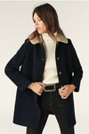 navy 3/4 length coat with faux fur collar, raglan pockets and marbled buttons  model shot