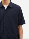 Close up of navy button through polo shirt