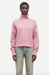 pink turtleneck jumper with ribbed neck, cuffs and hem model shot