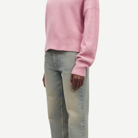 pink turtleneck jumper with ribbed neck, cuffs and hem side view