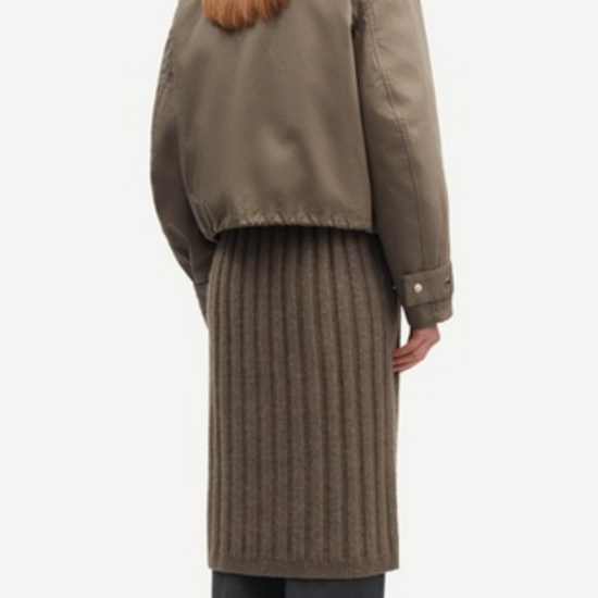 Rear view of short dark green jacket on a model