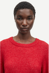 red round neck short jumper with ribbed neck, cuff and hem close up