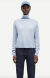 pale blue turtleneck jumper with ribbed neck, hem and cuffs model shot