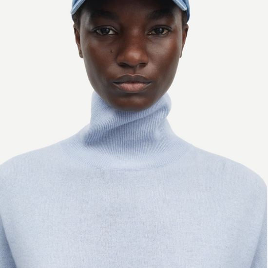 pale blue turtleneck jumper with ribbed neck, hem and cuffs close up