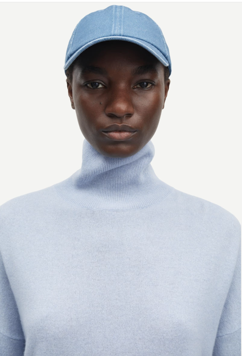 pale blue turtleneck jumper with ribbed neck, hem and cuffs close up