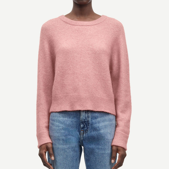 baby pink round neck knit with ribbed neck, cuffs and hem model shot