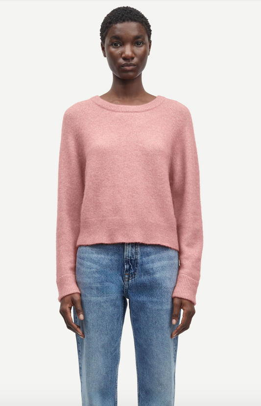 baby pink round neck knit with ribbed neck, cuffs and hem model shot