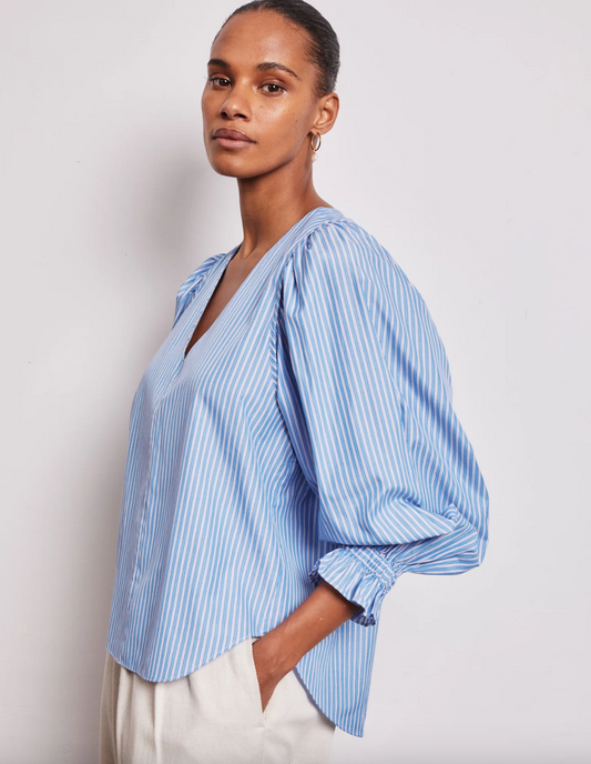 Side view of blue and white V neck stripe shirt