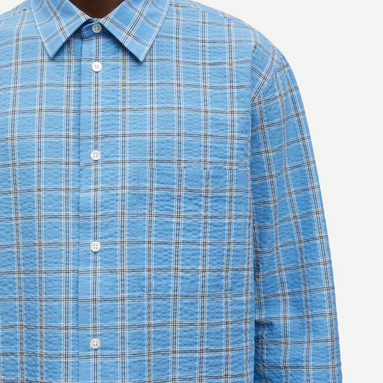 long sleeve shirt with blue check print and cheese cloth like fabric close u
