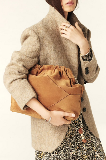 tan suede bag with scrunched top and gold chain strap model shot