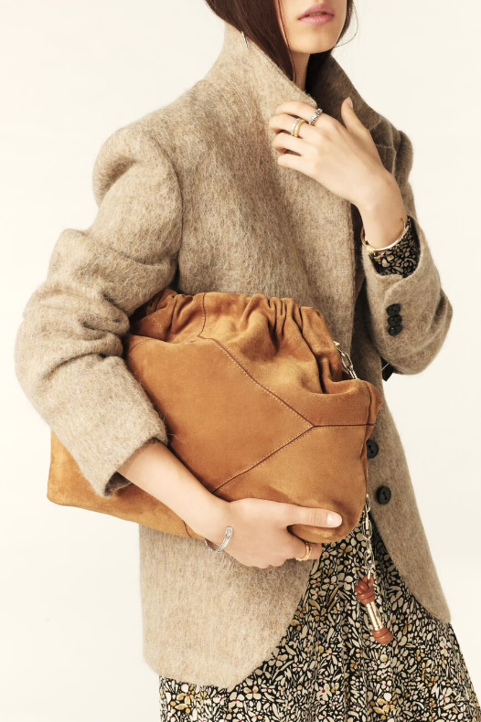 tan suede bag with scrunched top and gold chain strap model shot