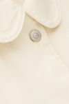 ecru cotton jacket with peter pan collar, 1 patch pocket and silver buttons close up