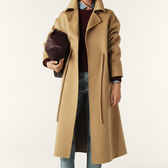 camel wool coat with concealed placket, tie belt which loops through the coat and side pockets model shot