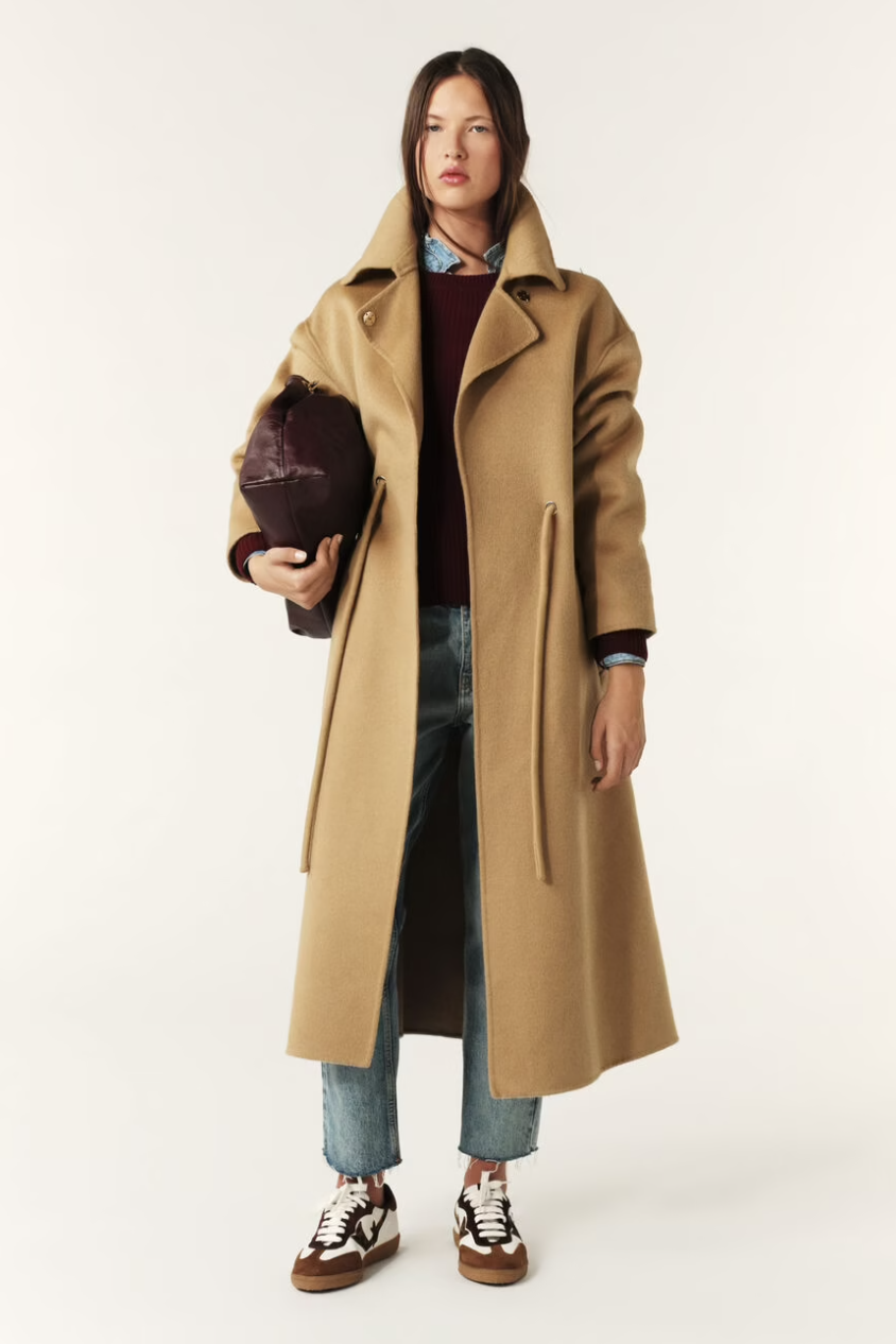 camel wool coat with concealed placket, tie belt which loops through the coat and side pockets model shot