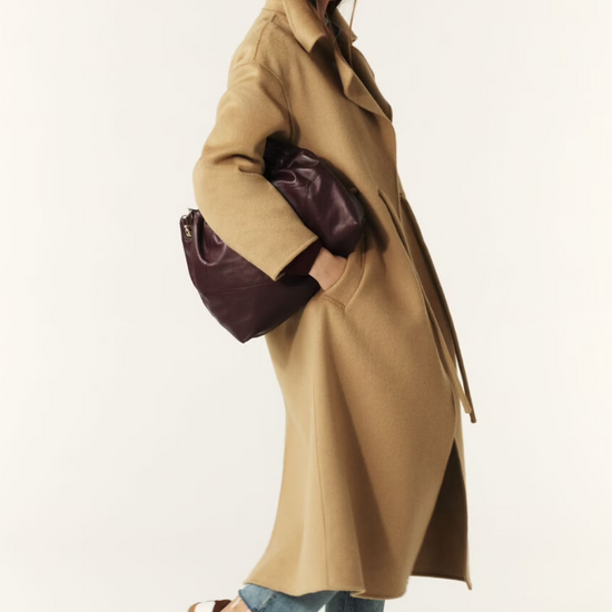 camel wool coat with concealed placket, tie belt which loops through the coat and side pockets side view