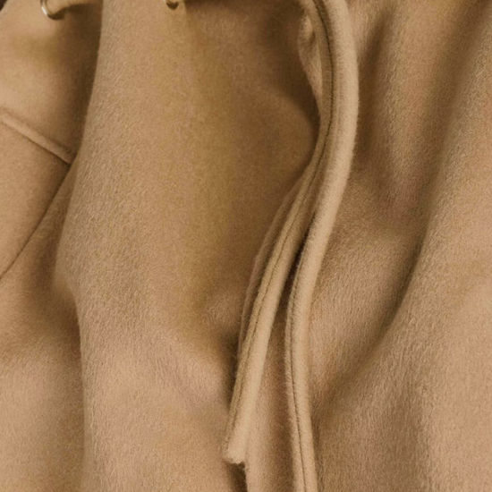 camel wool coat with concealed placket, tie belt which loops through the coat and side pockets close up