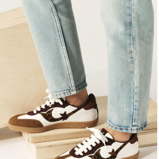 white leather trainers with brown suede to, back and animal print design on the side   model shot