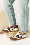 white leather trainers with brown suede to, back and animal print design on the side   model shot