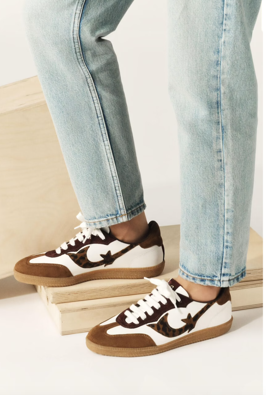 white leather trainers with brown suede to, back and animal print design on the side   model shot