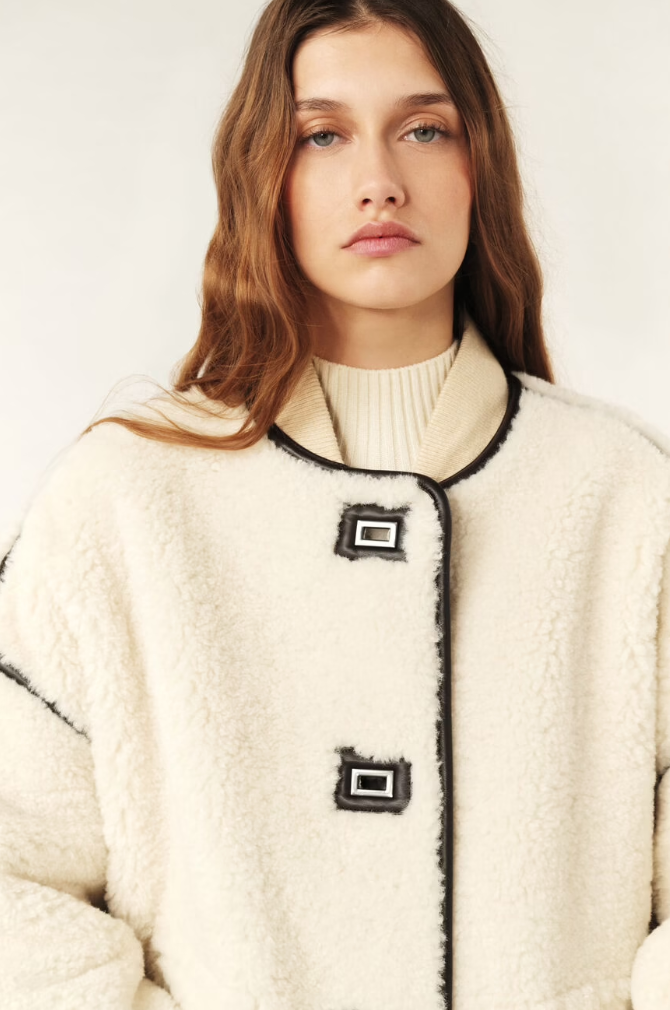 ecru faux fur shearling short jacket with brown leather piping, side pockets close up