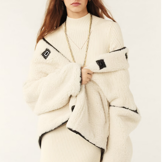 ecru faux fur shearling short jacket with brown leather piping, side pockets model shot