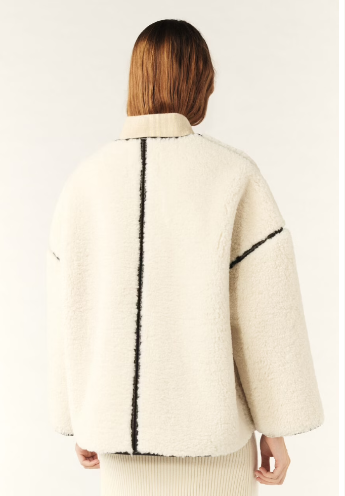 ecru faux fur shearling short jacket with brown leather piping, side pockets rear view 