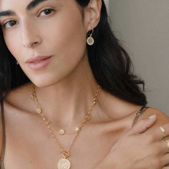 Gold bracelet with circular charms with dotting model shot