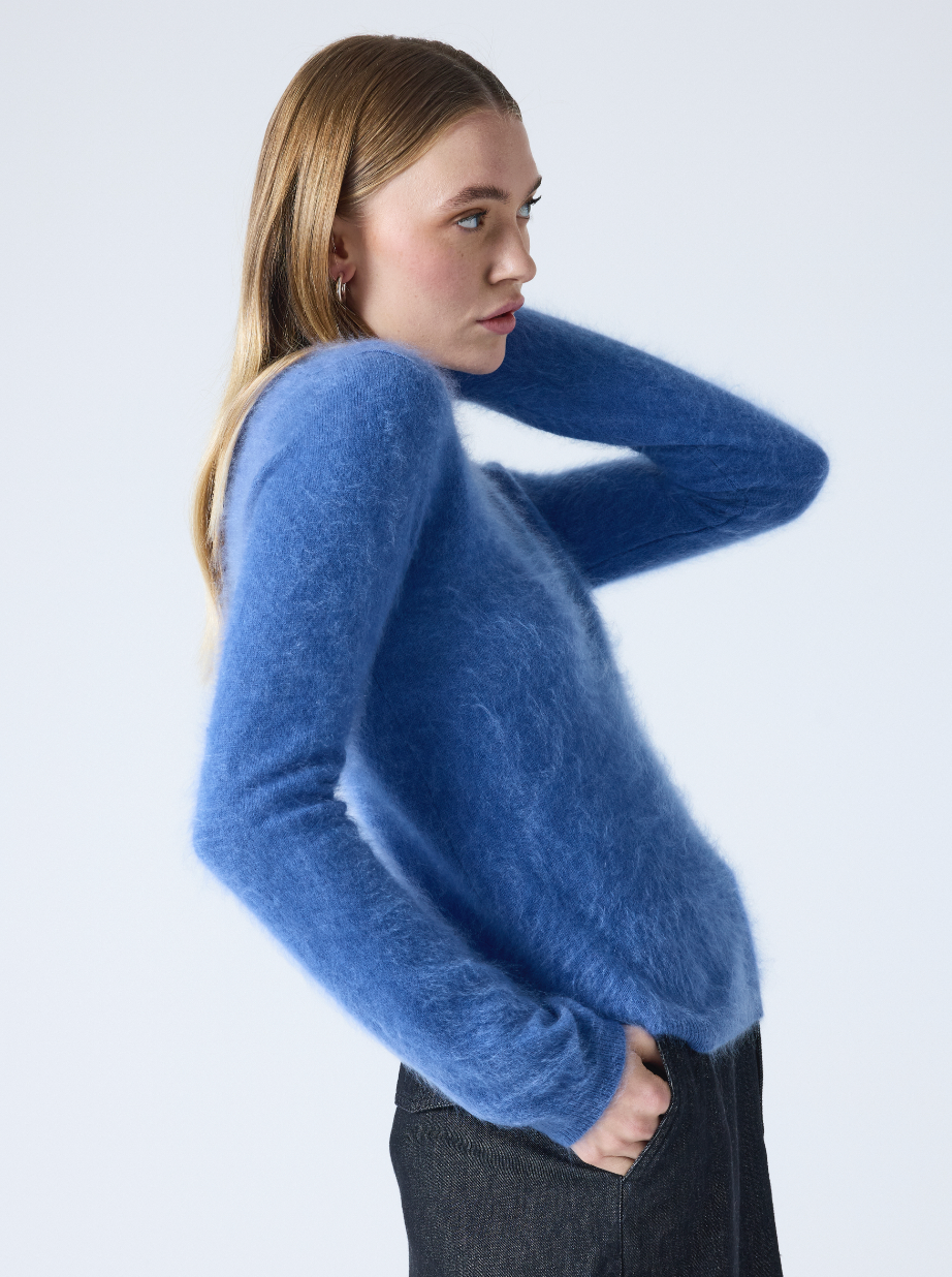 denim blue crew neck cashmere jumper with long sleeves and hairy textured feeling side view