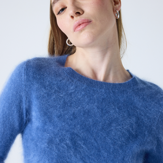 denim blue crew neck cashmere jumper with long sleeves and hairy textured feeling close up