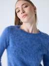 denim blue crew neck cashmere jumper with long sleeves and hairy textured feeling close up