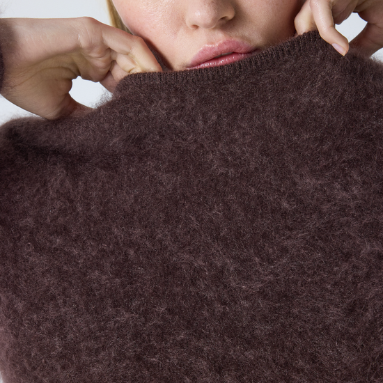 brown crew neck jumper with long sleeves and fluffy texture close up