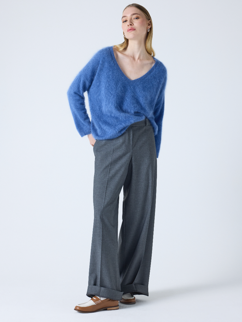 blue v neck jumper with long sleeves and fluffy texture model shot
