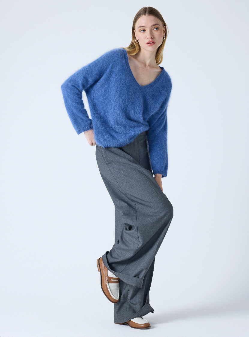 blue v neck jumper with long sleeves and fluffy texture model shot