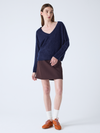navy v neck jumper with long sleeves and fluffy texture model shot