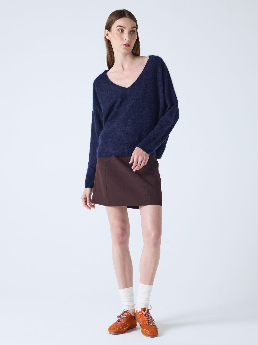 navy v neck jumper with long sleeves and fluffy texture model shot