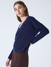 navy v neck jumper with long sleeves and fluffy texture side view