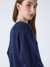 navy v neck jumper with long sleeves and fluffy texture close up