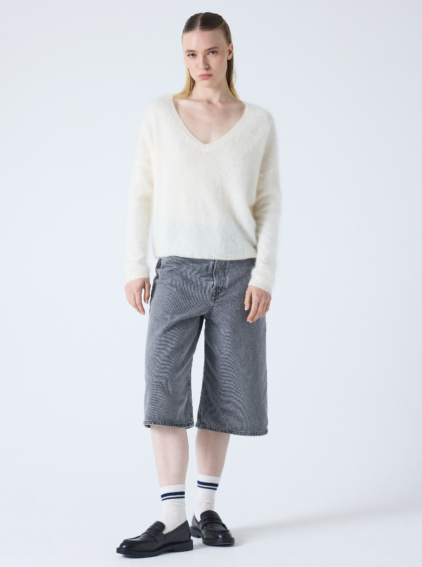 cream v neck jumper with long sleeves and fluffy texture model shot